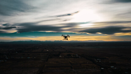 industrial drone flying at sunset