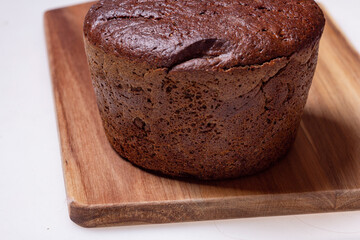 a loaf of homemade rye bread on a wooden board