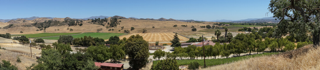 Santa Inez, CA, USA - April 3, 2009: San Lorenzo Seminary. Panorama shot over SW valley shows agriculture, mountains and dark foliage trees sprinkled around. © Klodien