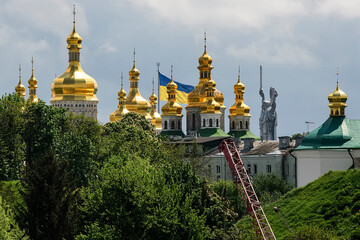 Fototapeta na wymiar Panorama view of the Kyiv Pechersk Lavra, The Motherland Monument and Giant State Flag Of Ukraine in Kyiv, Ukraine