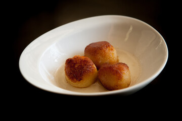 Gulab jamun an Indian dessert in a white bowl