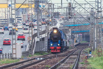 Retro steam train on highway background. Moscow.
