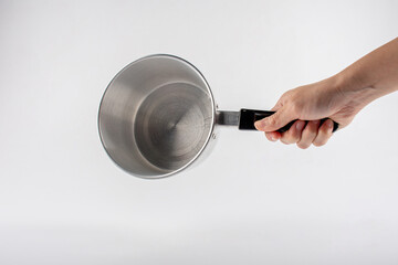 Hand holding a pot on white background.
