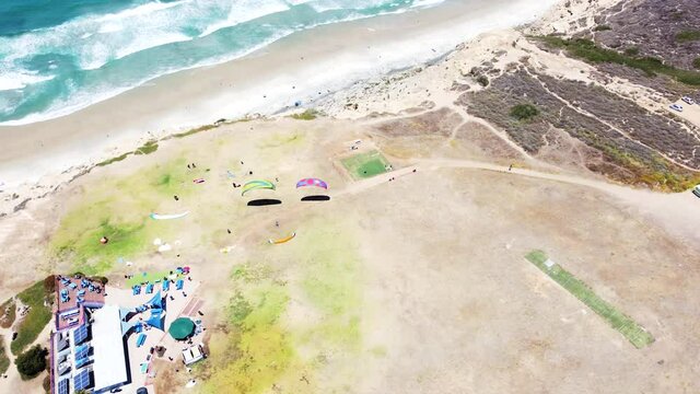Powered parachute sport at coastal cliff side in aerial drone view