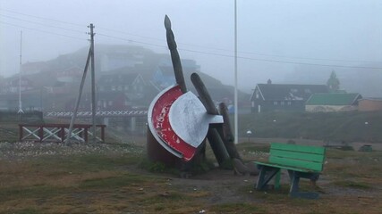 Paamiut, city in Greenland. Old bridge of the city in the background, and a playground shaped as a ulu. It was a foggy day. Filmed in 2009 august 19.