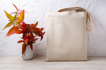 Rustic tote bag mockup with red grass in the vase