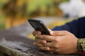 Muslim Woman typing with her smartphone