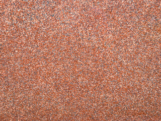 red crushed pebble rock stone mix set as garden path sidewalk roadway drive in a closeup overhead view