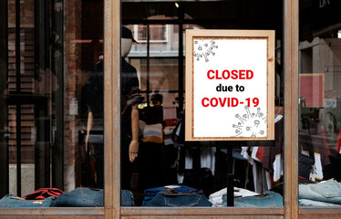 Fototapeta na wymiar Posters announce in front of business offices or stores that have closed due to the impact of the spread of the novel coronavirus disease (COVID-19).