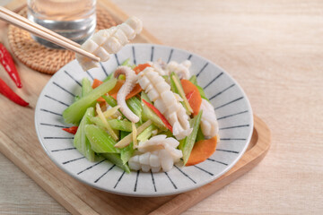 Stir-fried neritic squid with celery. Delicious homemade seafood with vegetable meal.