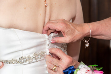 Zipping up bridal dress