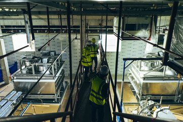 Mechanical engineer team working installation condensing unit system in machine room for cold...