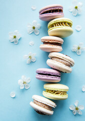 Colorful macaroons  arranged over blue background.