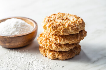 Sweet coconut cookies and ground coconut. Tasty biscuits with coconut flavor