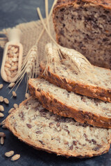 Fresh wholegrain bread for breakfast and ears of rye or wheat grain