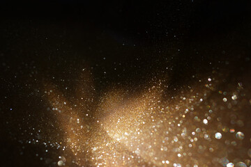 background of abstract gold and black glitter lights. defocused