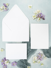 Blank wedding stationery cards and envelope and fresh flower flat lay