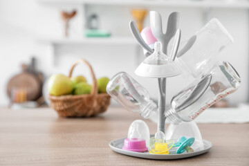 Drying rack for baby bottles on table in kitchen