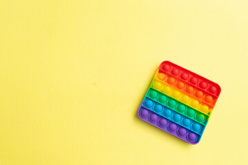 Antistress toy pop it fidget on yellow background.