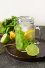 Mason jar of lemonade with basil on table