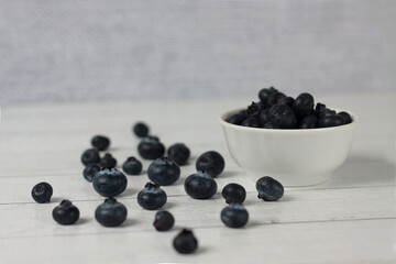 Fototapeta na wymiar a bowl of blueberry and berries on wooden background