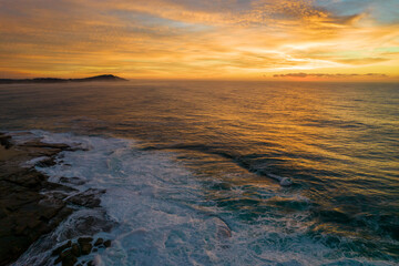Obraz premium Aerial Sunrise Seascape at Rocky Inlet with colourful high cloud