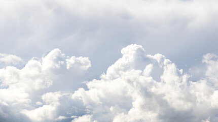 thick white clouds and a blue sky. cummulus clouds predict bad weather. 
