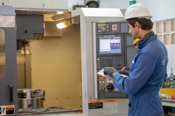Workers inspecting workpieces from CNC machines. The worker measures the part installed on the...