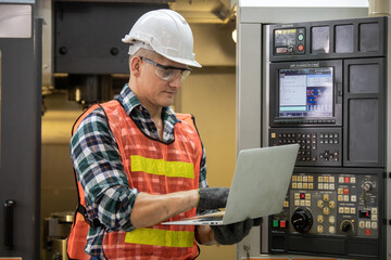 Engineer control and check robot working in factory. The worker is controlling the robot to work in the factory. Portrait of female factory worker.  Engineer women are working with machines cnc