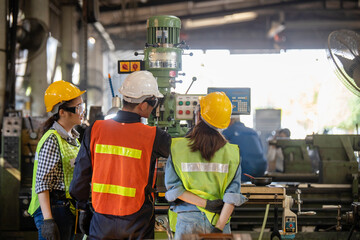 Asian Group industrial manager man demonstration and training mechanic worker woman  operating...