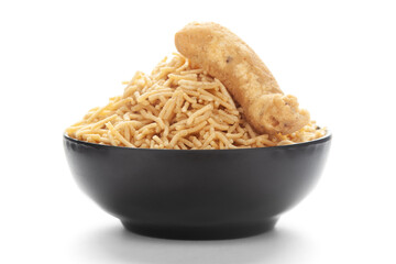 Close-Up of Indian spicy snacks (Namkeen) - Bikaneri Besan Bhujia in a black Ceramic bowl, made with chickpea flour (Besan),