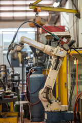 industrial machine and factory robot arm. robotic machine work together inside industrial building....