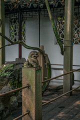 Close view of stone lions in a traditional Chinese garden.