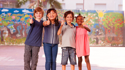 Happy children in a multi ethnic elementary classroom