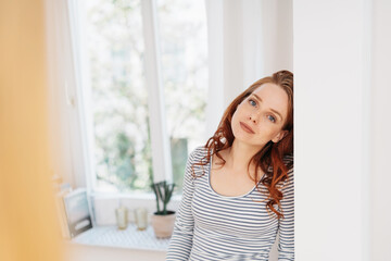 Thoughtful pensive young woman staring at the camera