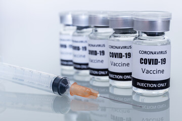 Many Vaccine bottles and syringes for preventing coronavirus or covid-19. Select focus