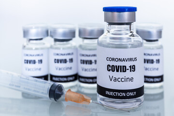 Many Vaccine bottles and syringes for preventing coronavirus or covid-19. Select focus