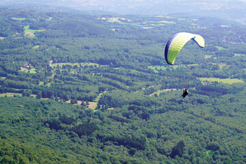 Paraglider in sky over volcano mountain the Puy de Dome France