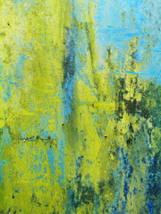 background of a very old metal rusty wall painted with bright blue paint and poisonous green