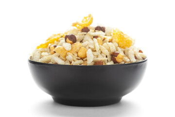 Close-Up of Crunchy Diet Mixture in a black Ceramic bowl made with Puffed Rice, Corn Flakes, and Curry leaves. Indian spicy snacks (Namkeen),