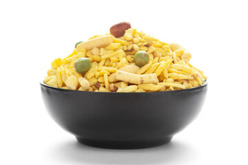 Delicious Khatta Meetha in a black Ceramic bowl, made with peanuts, sugar, raisins, and besan sev. Pile of Indian spicy snacks (Namkeen)