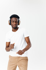 Cheerful man in headphones dancing listening to music