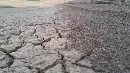 Grey dry soil surface with cracks , Soil drought cracks texture background , Skin soil arid cause from heat, Global warming and drought concept