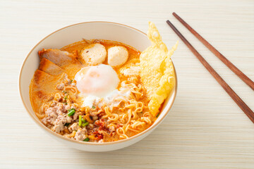 instant noodles with pork and meatballs in spicy soup