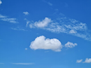 Naklejka na ściany i meble The blue sky and the clouds streaked like cotton wool.