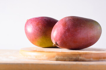 Fresh palmer mango fruit on wooden with white background, Tropical fruit
