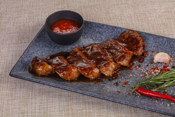 Grilled pork steak with tomato sauce