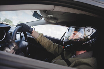 Rally driver concept. Man in the helmet drives a car.