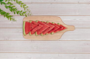 Sliced ​​watermelon in a wooden bowl on the table