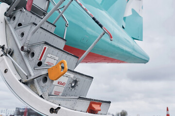 Doors is open. Turboprop aircraft parked on the runway at daytime